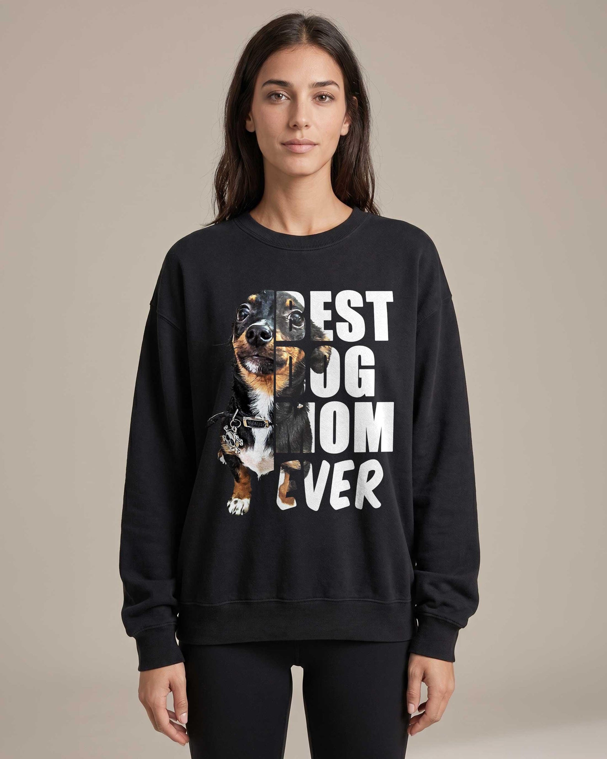 Woman wearing a white crew-neck sweatshirt with a custom golden dog portrait and the words Best Dog Mom Ever printed on the back in bold mixed lettering.