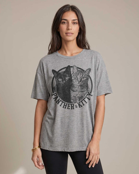 Woman wearing heather grey custom cat photo t-shirt with circular vintage-style graphic showing two cats and the text Panther and Kitty, relaxed unisex fit on neutral background.